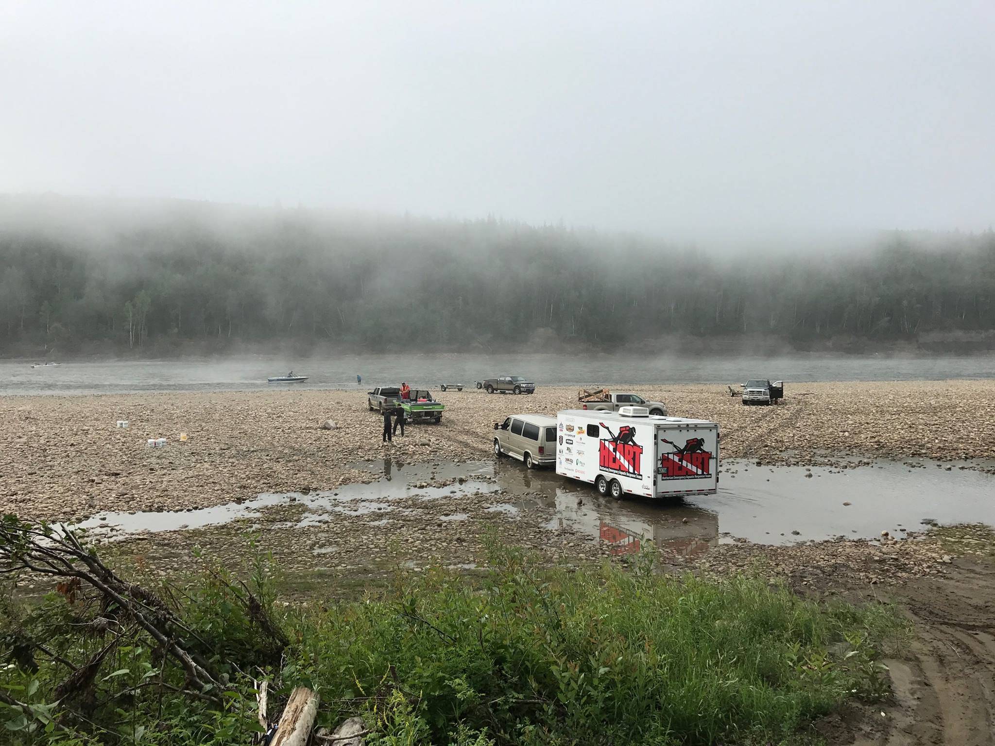 HEART vehicles on a river bar during a search